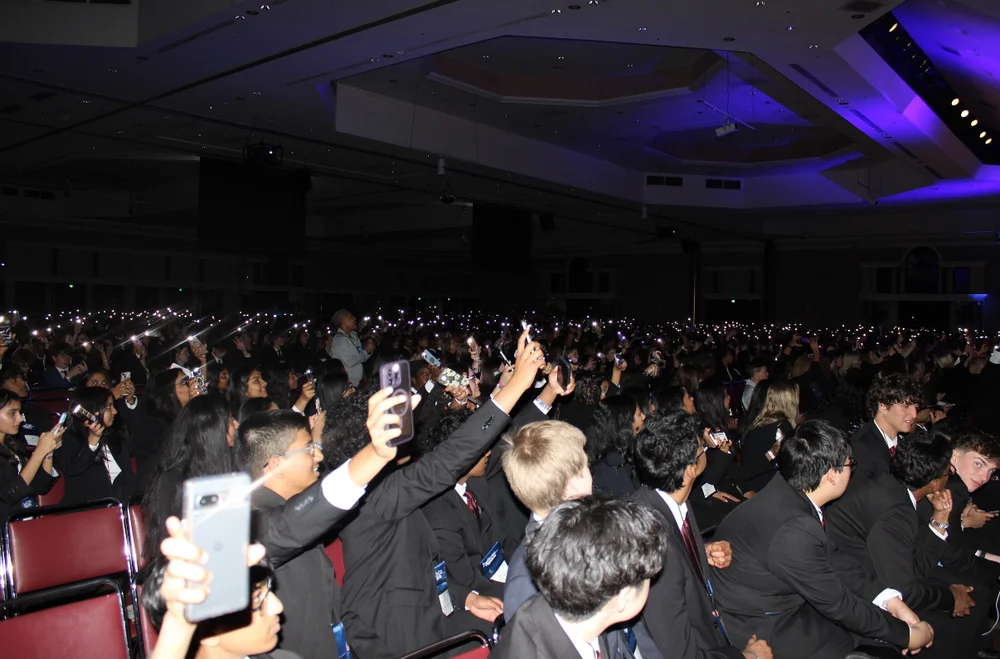 Crowd lighting up the hall