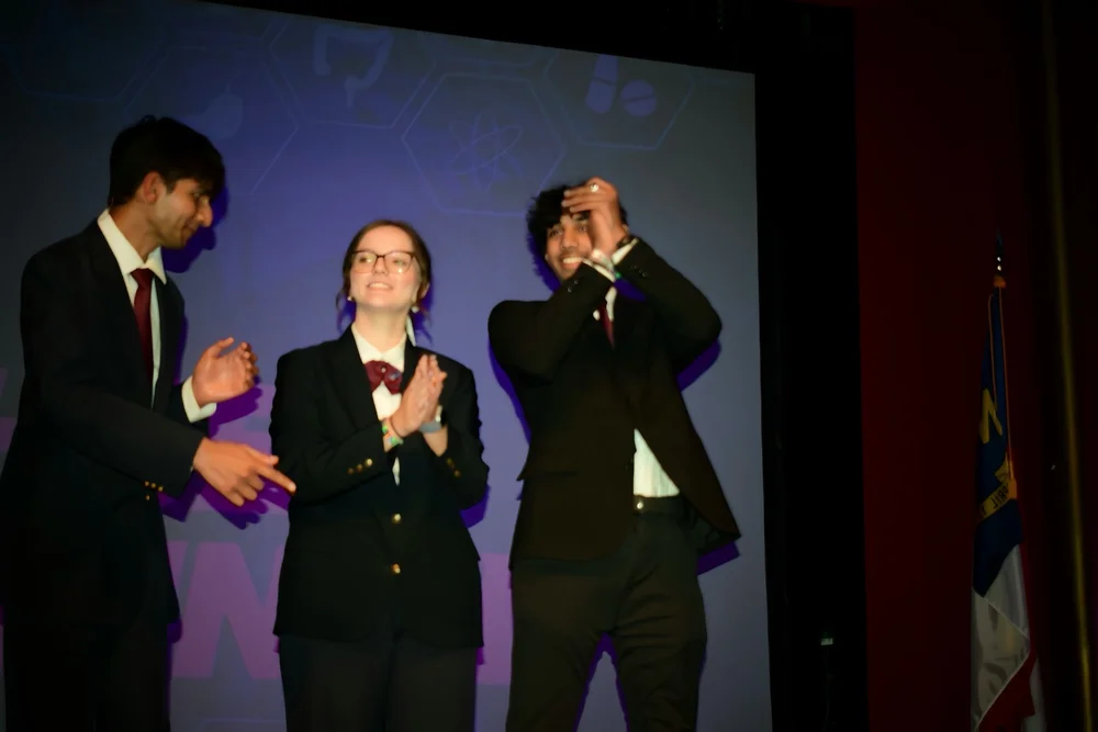 Cheering on stage with peers